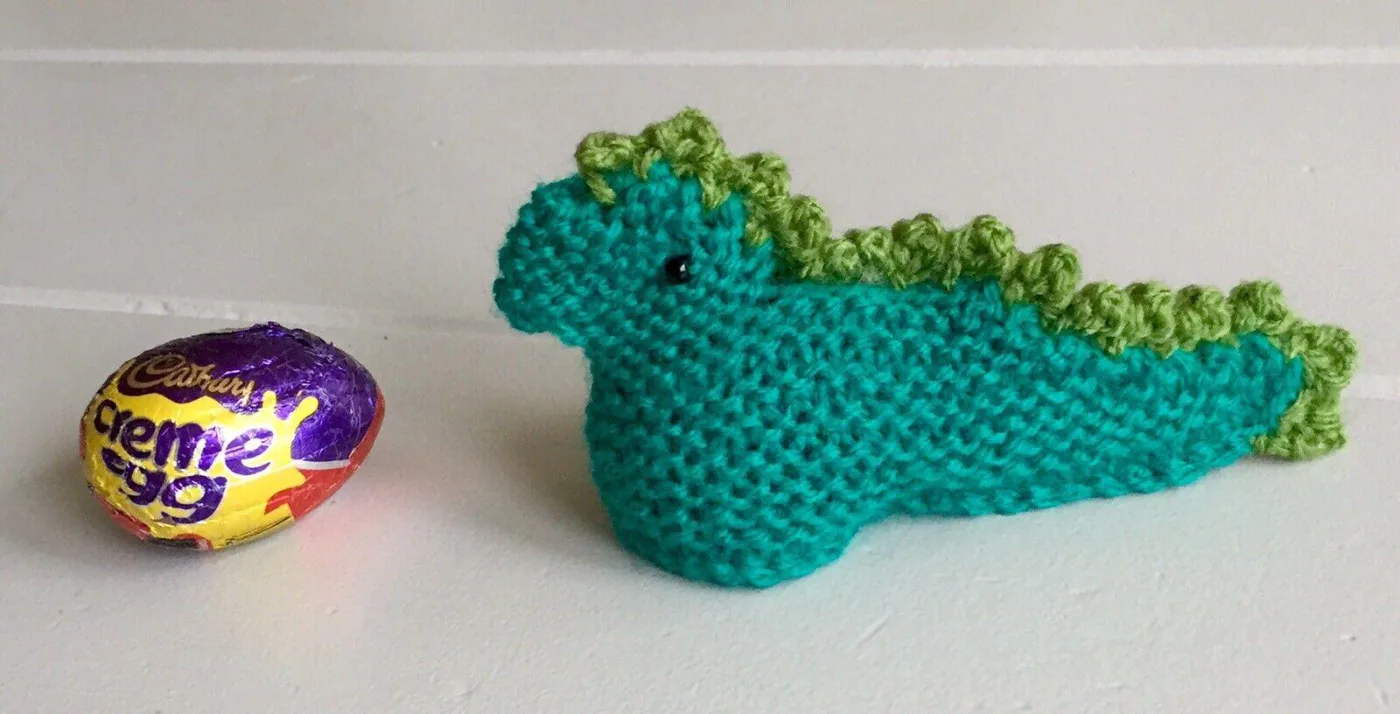 Hand knitted dinosaur creme egg cover with egg